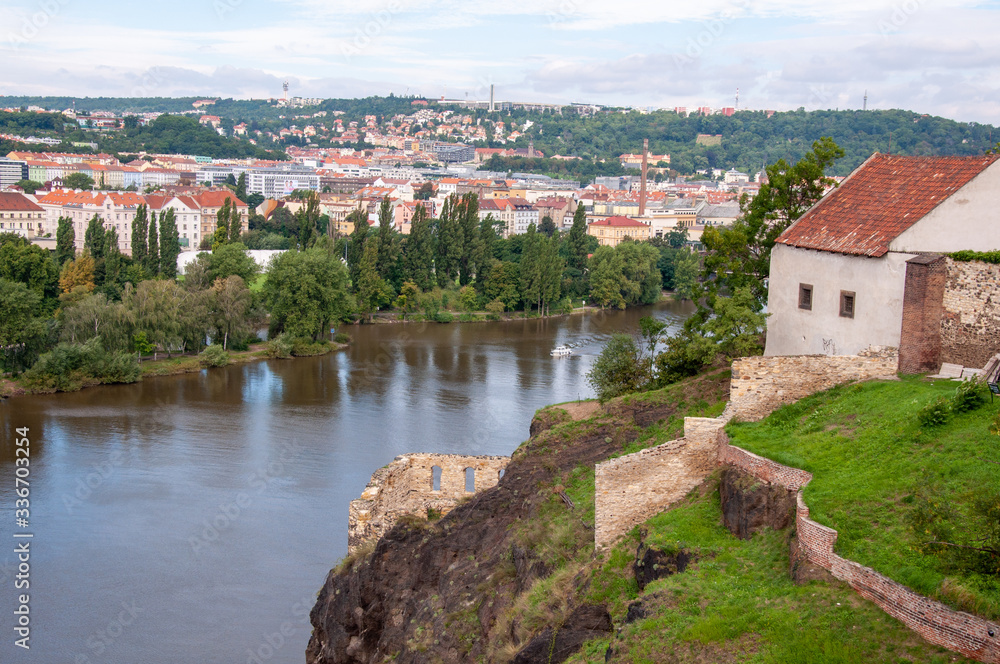 Obraz premium Beautiful and picturesque view of the city and river from the high mountain. A ship is sailing down the river.