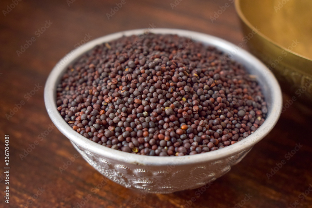 Mustard seeds in a Silver bowl on wooden old Table. Rustic Style Mustard seeds in a Silver bowl on wooden old Table. Rustic Style