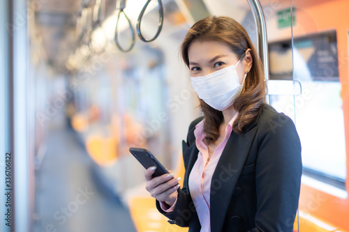 Woman wearing mask in subway.