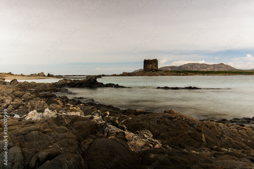 La Pelosa rocky beach and tower in Sardegna island in Italy