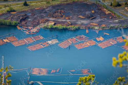 Logging company stacking and sorting piles of logs on Howe sound in Squamish, British Columbia. photo