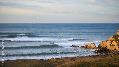 Azkorri (getxo Basque Country) beach at sunset Waves coming and rocks