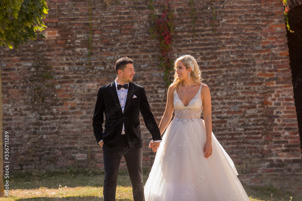 Happy wonderful wedding couple walking together in nature Happy wonderful wedding couple walking together in nature