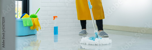 Young housekeeper or washing cleaning floor at mop in protective gloves  Housework Cleaning service.