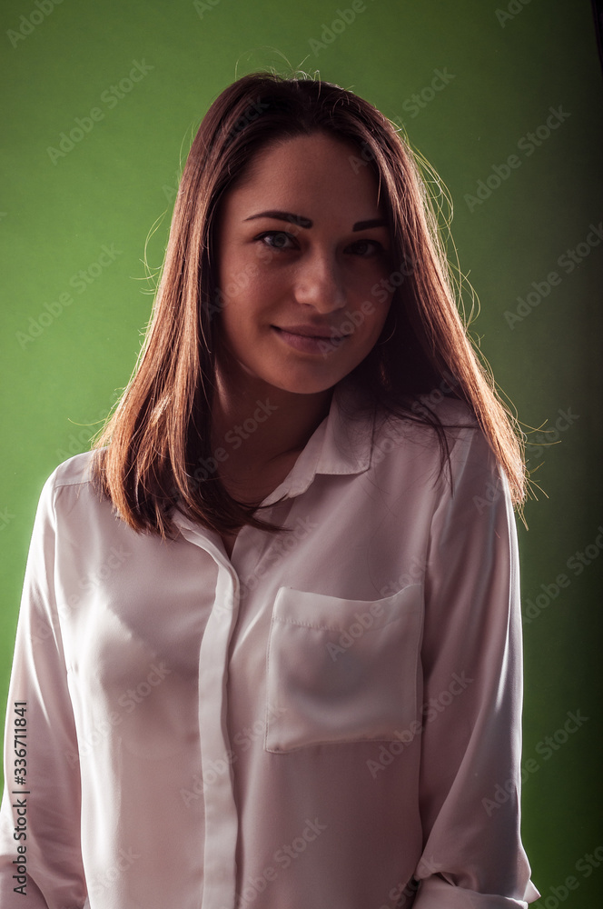 Pretty happy young girl is smiling to the camera from the darkness Pretty happy young girl is smiling to the camera from the darkness