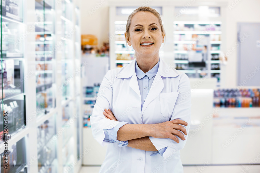 Positive female pharmacist looking contented and smiling