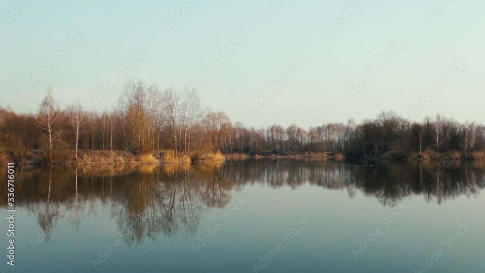 Reflection of trees in the water at early spring Reflection of trees in the water at early spring
