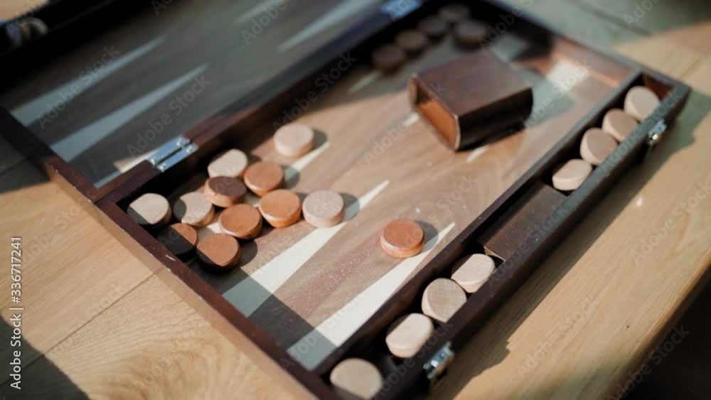 Tilt down close up of old traditional backgammon board game during sunny day