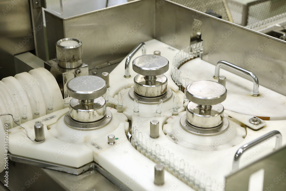 Pharmaceutical industry. Production Line. Machine conveyor with glass bottles, ampoules in a factory. Fill bottles and ampoules for solid particles in liquid and container defects. Pharmaceutical Pharmaceutical industry. Production Line. Machine conveyor with glass bottles, ampoules in a factory. Fill bottles and ampoules for solid particles in liquid and container defects. Pharmaceutical