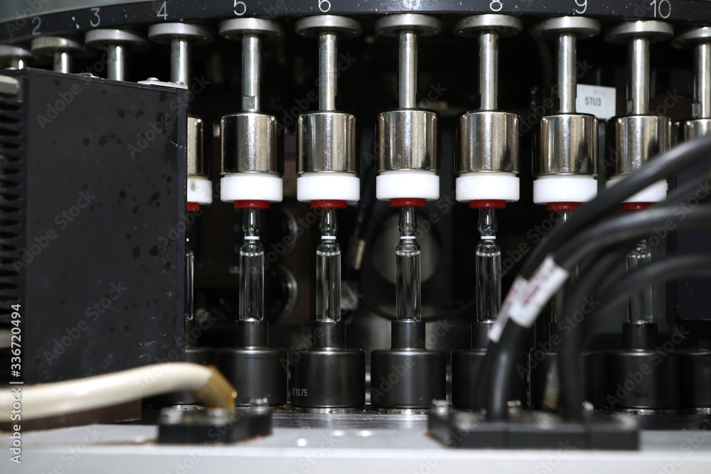 Pharmaceutical industry. Production Line. Machine conveyor with glass bottles, ampoules in a factory. Fill bottles and ampoules for solid particles in liquid and container defects. Pharmaceutical Pharmaceutical industry. Production Line. Machine conveyor with glass bottles, ampoules in a factory. Fill bottles and ampoules for solid particles in liquid and container defects. Pharmaceutical