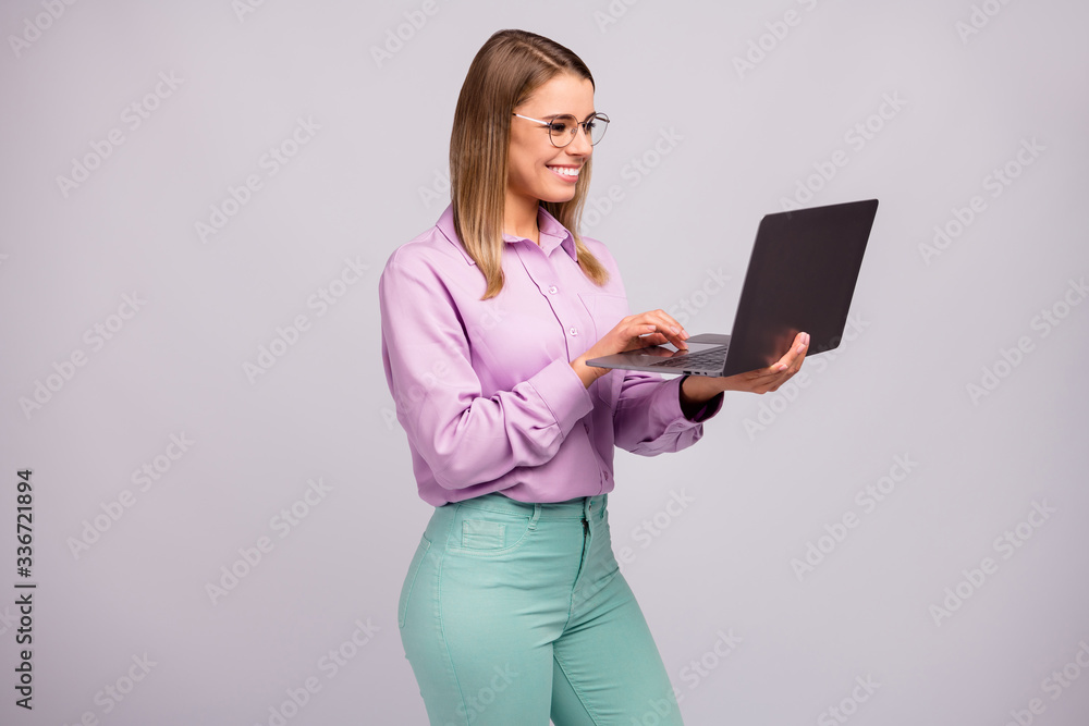 Portrait of positive confident smart manager girl work distance use laptop read social blogging news wear mint violet clothes isolated over gray color background Portrait of positive confident smart manager girl work distance use laptop read social blogging news wear mint violet clothes isolated over gray color background