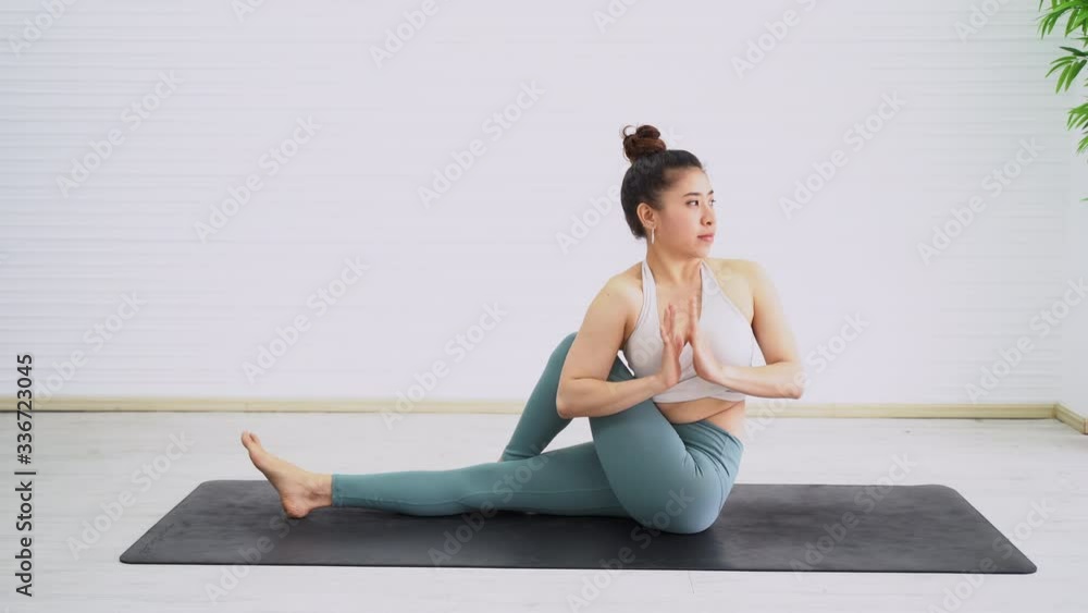 Beautiful young woman doing yoga exercise in room. Female stretching body with relax. Showing skills of strength & balance. Beautiful young woman doing yoga exercise in room. Female stretching body with relax. Showing skills of strength & balance.