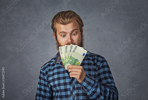 business man executive, CEO, boss, corporate employee holding euro on grey photo