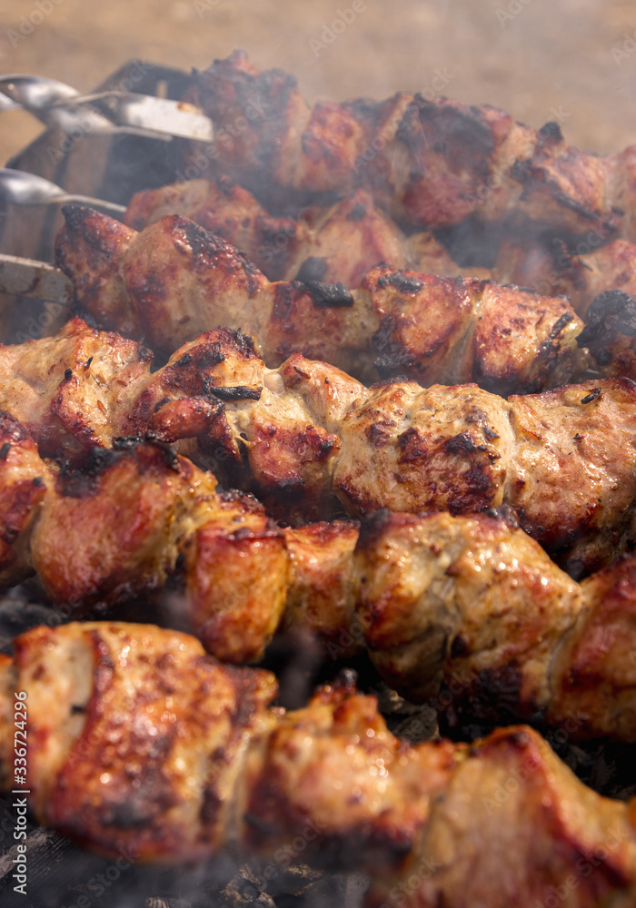 Nice, tasty, closeup grilled meat shashlik with a golden crust. Vertical photo