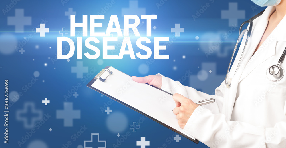 doctor writes notes on the clipboard with HEART DISEASE inscription, first aid concept doctor writes notes on the clipboard with HEART DISEASE inscription, first aid concept