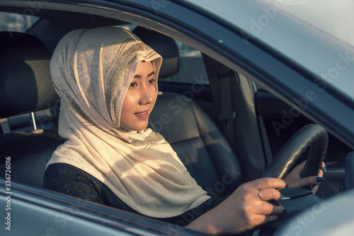 Islamic woman wearing hijab driving car and buy new car. © Supavadee