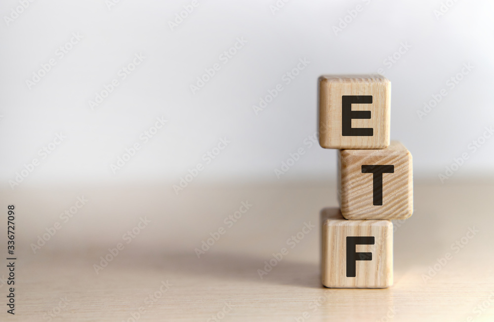 ETF - Exchange Traded Fund text on wooden cubes, on white background ETF - Exchange Traded Fund text on wooden cubes, on white background
