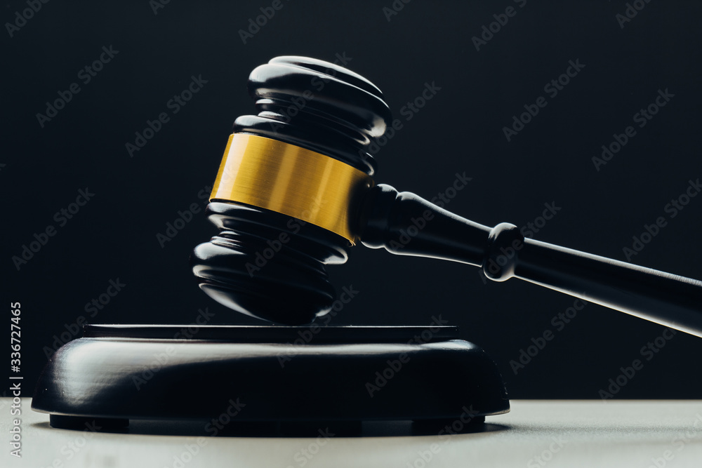 Judge's gavel with gold metal on a black table. Concept of law Judge's gavel with gold metal on a black table. Concept of law