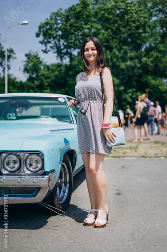 Beautiful girl near a blue muscle car © chdenisz