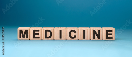 MEDICINE word cube on a blue background. Medical concept.