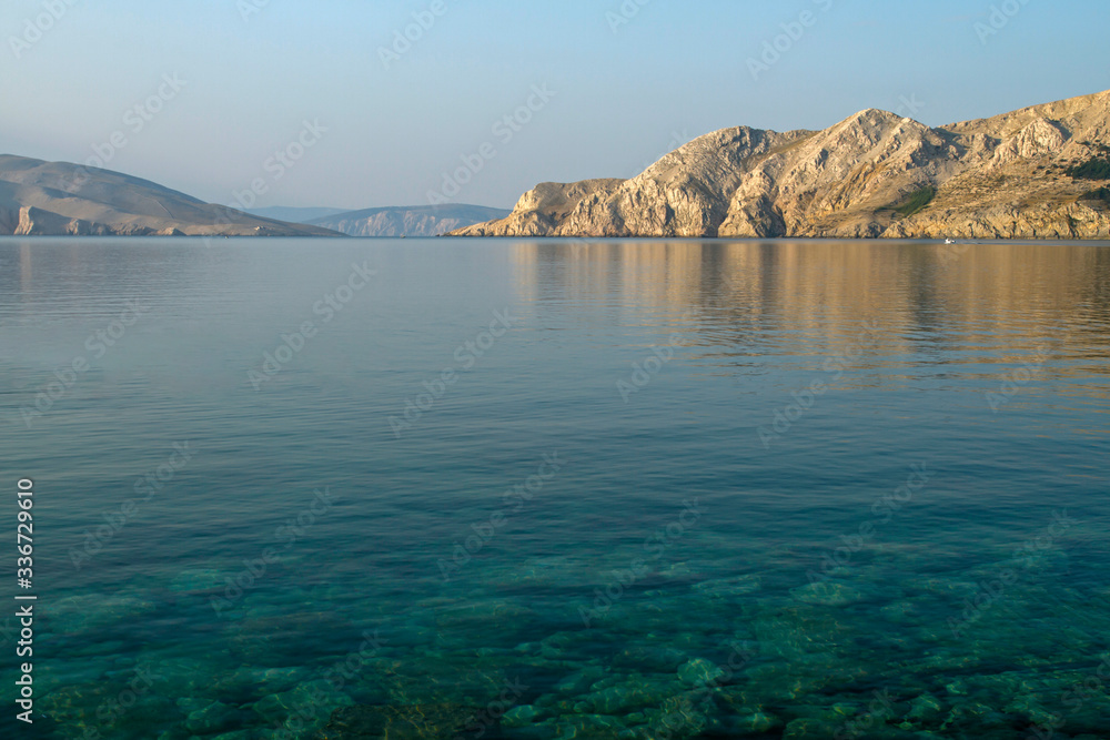Croatian beach at a sunny morning.  Island Krk. Adriatic coast. Europe. Summer vacation. Relaxation Concept. Beaches of Croatia.