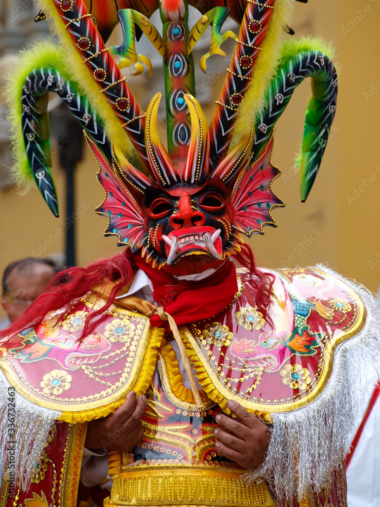 Traditional very colorful mask of a demon at carnival celebrations in Lima, Peru