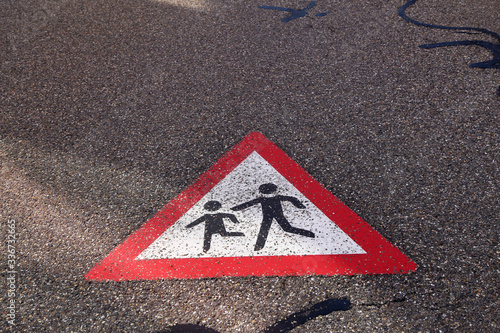 Children on the road, sign painted on the asphalt photo