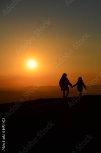 Mother and daughter watching the sunset.