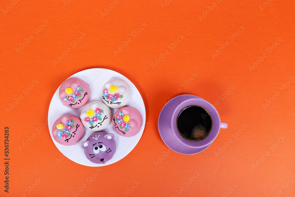 beautiful cakes and a cup of coffee on an orange background beautiful cakes and a cup of coffee on an orange background