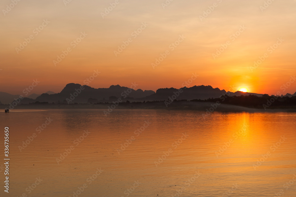 Beautiful sunset at Salween river in Hpa An, Myanmar. Calm river and hills in Myanmar.