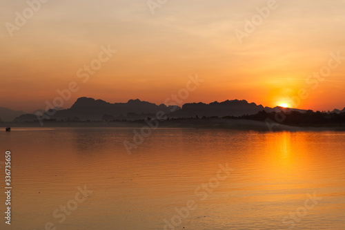 Beautiful sunset at Salween river in Hpa An, Myanmar. Calm river and hills in Myanmar.