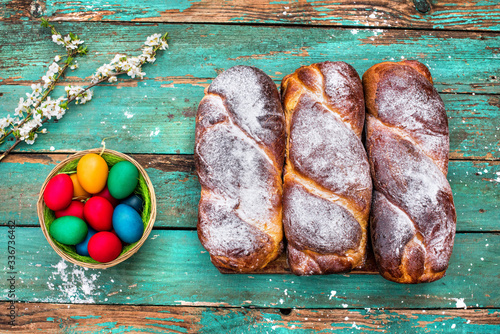 Romanian traditional walnut sweet bread - cozonac with natural dye colored easter eggs