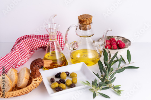 Table with oil cans  olives  bread and radishes