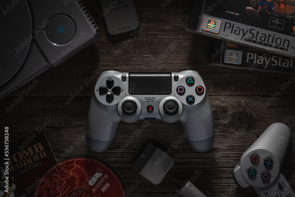 Odessa, Ukraine - December 7, 2019: The DualShock4 Wireless Controller for  PlayStation4. Gamepad gray for PS4 on a vintage wooden table among the PS1  console and games. Stock-Foto | Adobe Stock