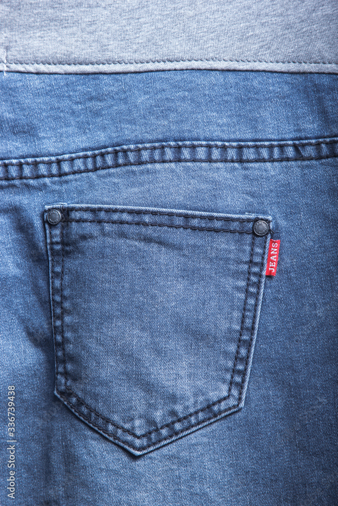 back pocket of denim trousers. with ripped denim jeans close up for pregnant women back pocket of denim trousers. with ripped denim jeans close up for pregnant women