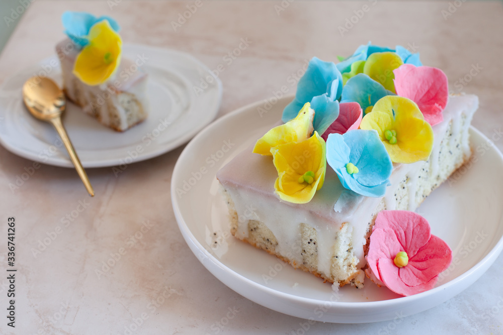 Lemon and poppy seeds loaf cake decorated with pastel fondant flowers Lemon and poppy seeds loaf cake decorated with pastel fondant flowers