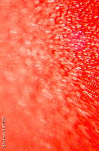 Abstract background and texture. Bright highlights on a red synthetic surface