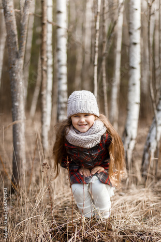 little cute girl in the birch forest in spring
