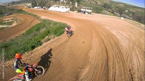 Motocross bikes jumping on slow motion, recorded with a FPV race drone photo