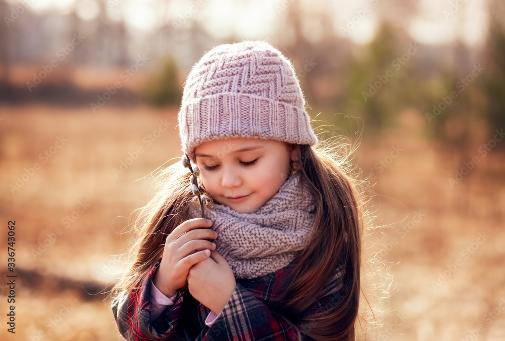 portrait of a little girl in a hat in the spring forest portrait of a little girl in a hat in the spring forest