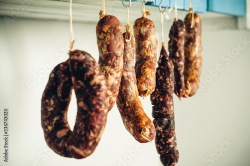 jerky, smoked meats and sausages hanging close up