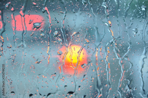 Abstract grunge background. Heavy rain droplets on the car window