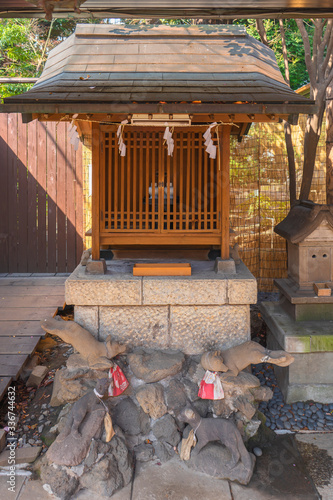 Small massha shrine dedicated to Ukanomitama deity or inari kitsune god of rice in the Atago shrine on the highest mountain in Tokyo. photo