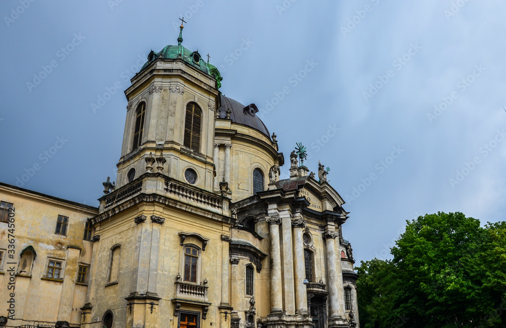 Main facade of The Dominican church (Holy Eucharist) and monastery with huge bell tower and dome, tall columns t the entrance in Lviv, Ukraine is located in the city`s Old Town