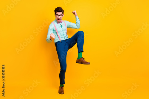 Full length photo positive cheerful delighted man celebrate corona virus defeat victory raise fists scream yeah wear blue pants pink bow tie bowtie isolated bright shine color background