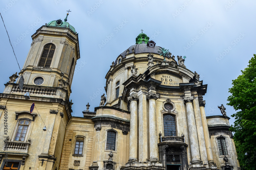 Main facade of The Dominican church (Holy Eucharist) and monastery with huge bell tower and dome, tall columns t the entrance in Lviv, Ukraine is located in the city`s Old Town