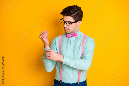 Portrait of luxury chic imposing man fix correct his button prepare for valentine date day wear stylish outfit isolated over vivid color background