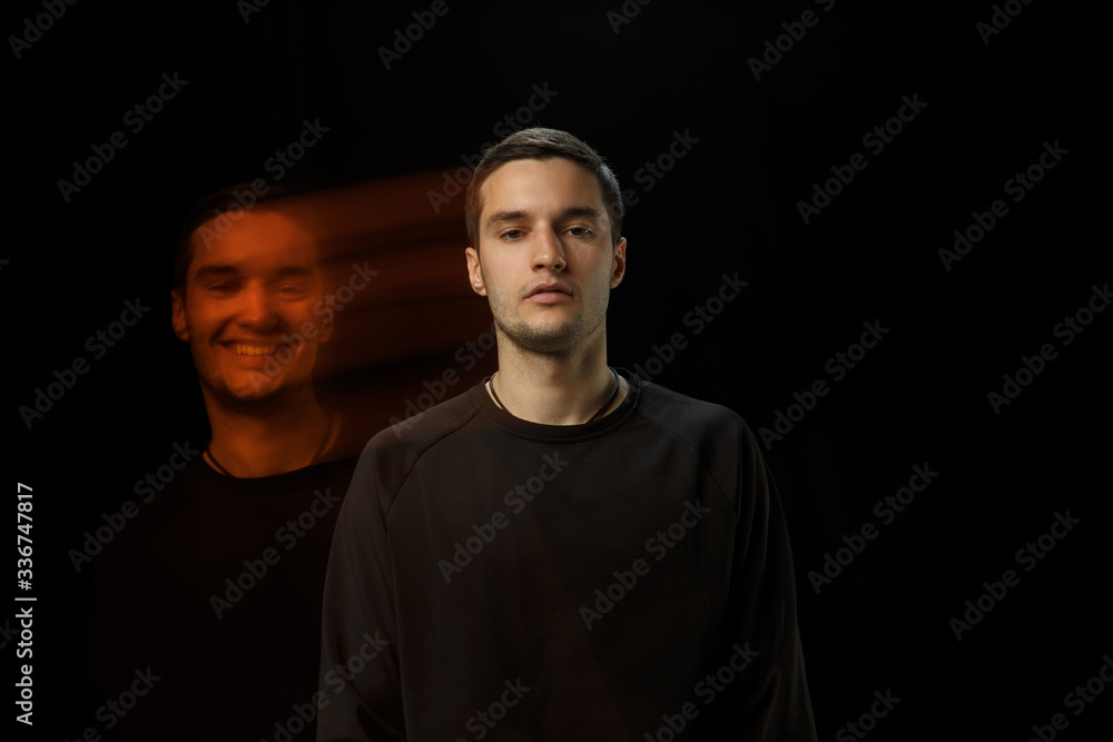 Cold outside, happy inside. The versatility of man - opened emotions and hidden feelings. Caucasian man on black background with different faces of condition. Double exposure. Mental health. Cold outside, happy inside. The versatility of man - opened emotions and hidden feelings. Caucasian man on black background with different faces of condition. Double exposure. Mental health.