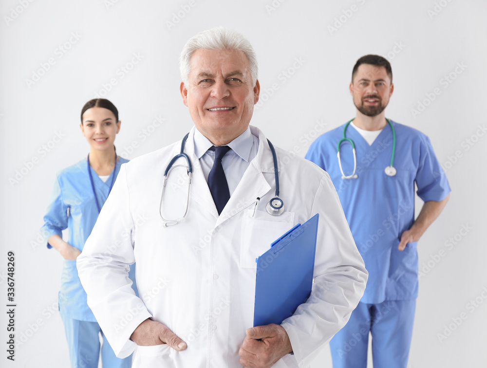 Group of doctors against light background. Medical service Group of doctors against light background. Medical service
