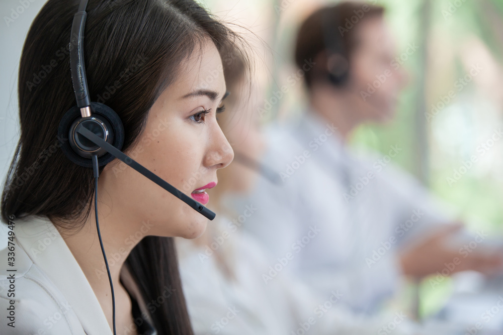 operator woman agent with headsets working in a call centre. woman asian Smiling customer support operator at working operator woman agent with headsets working in a call centre. woman asian Smiling customer support operator at working